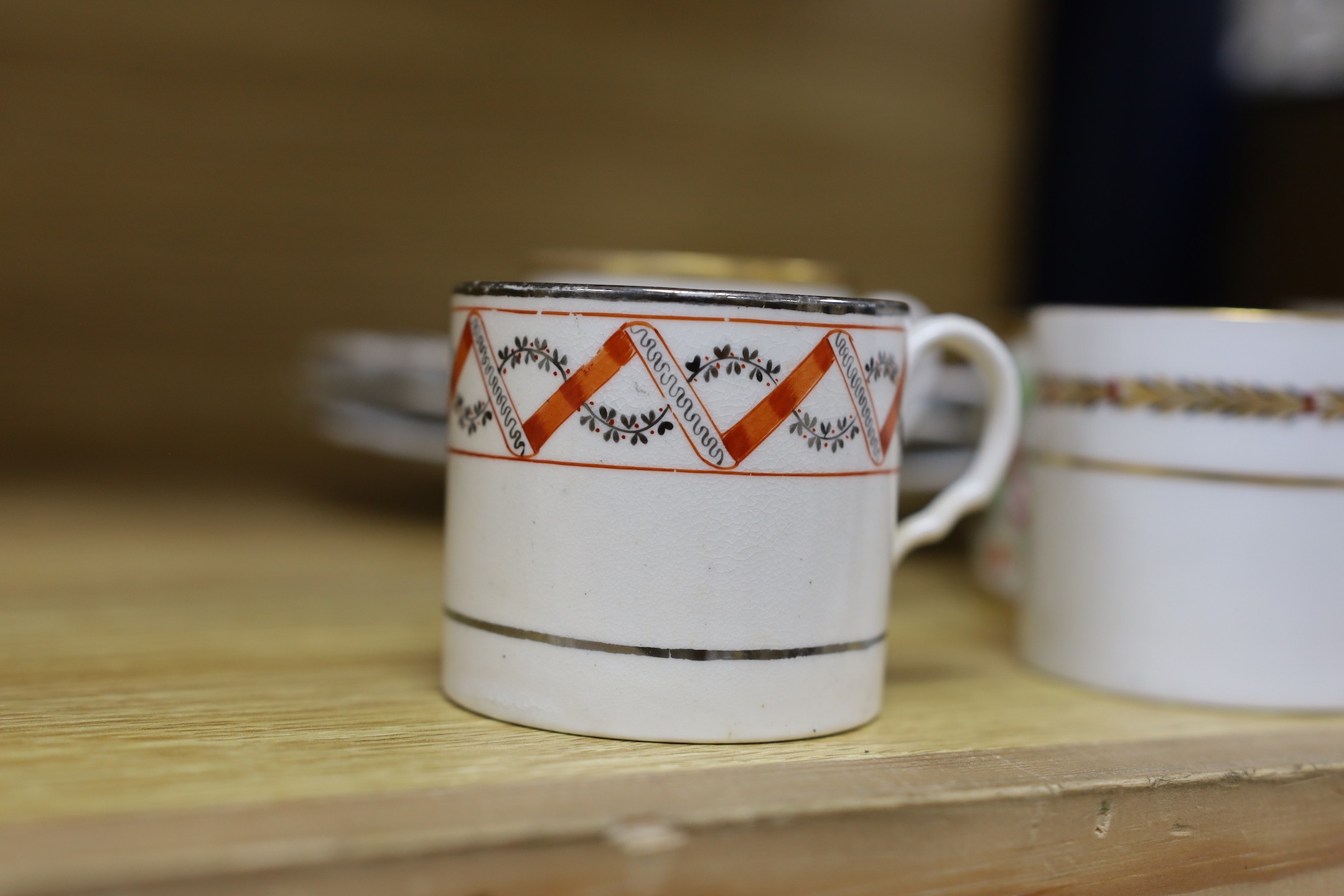 Seven early 19th century coffee cans and three Ridgway Imari style plates, plates 23 cms diameter